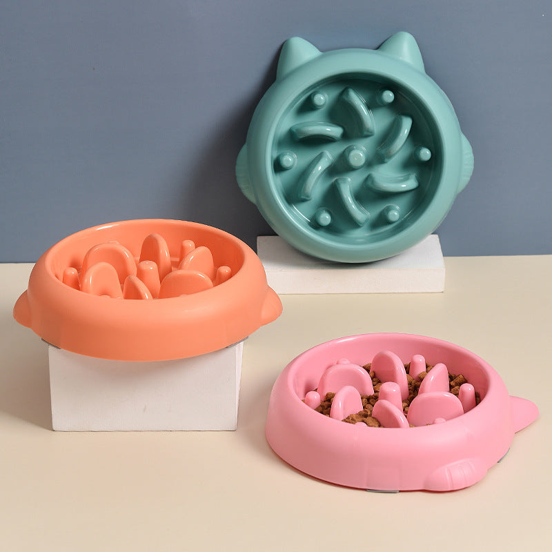 Three colorful pet bowls with textured surfaces on a neutral background
