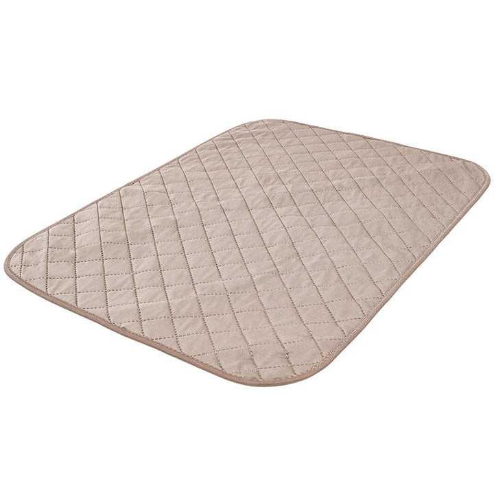Quilted beige mat on a white background