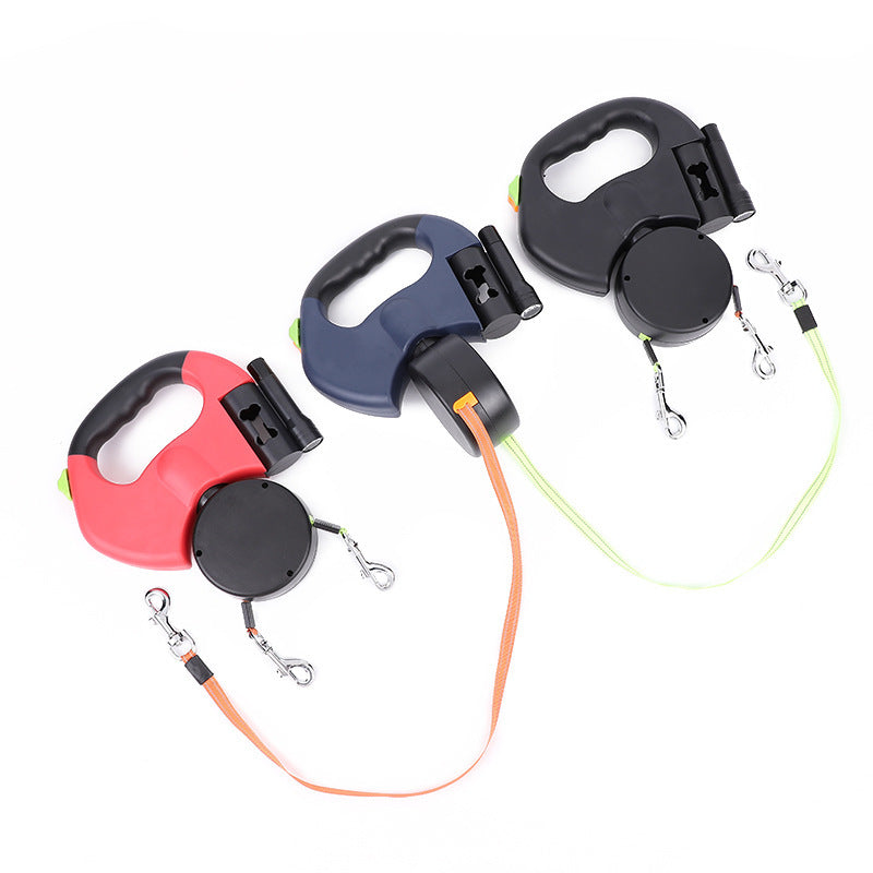 Three retractable dog leashes in different colors on a white background