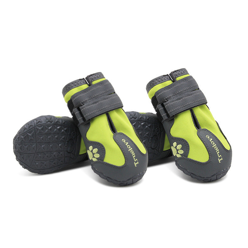 Pair of green and gray pet boots with paw design on a white background