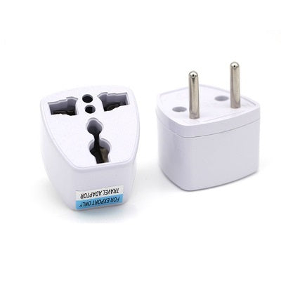 Two travel adapters on a white background