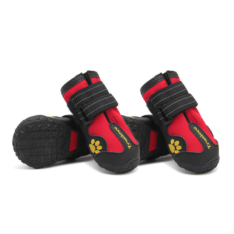 Red and black dog boots with yellow paw design on a white background