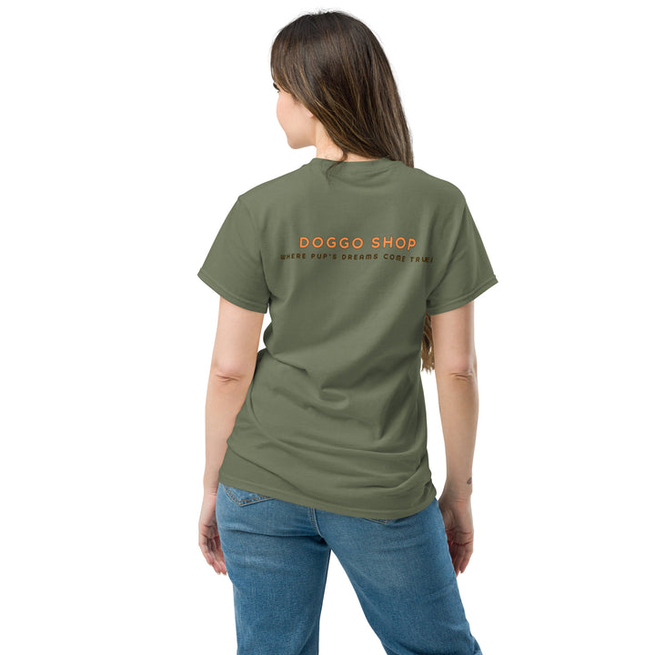 Person wearing a green t-shirt with 'Doggo Shop' text on the back, standing against a white background