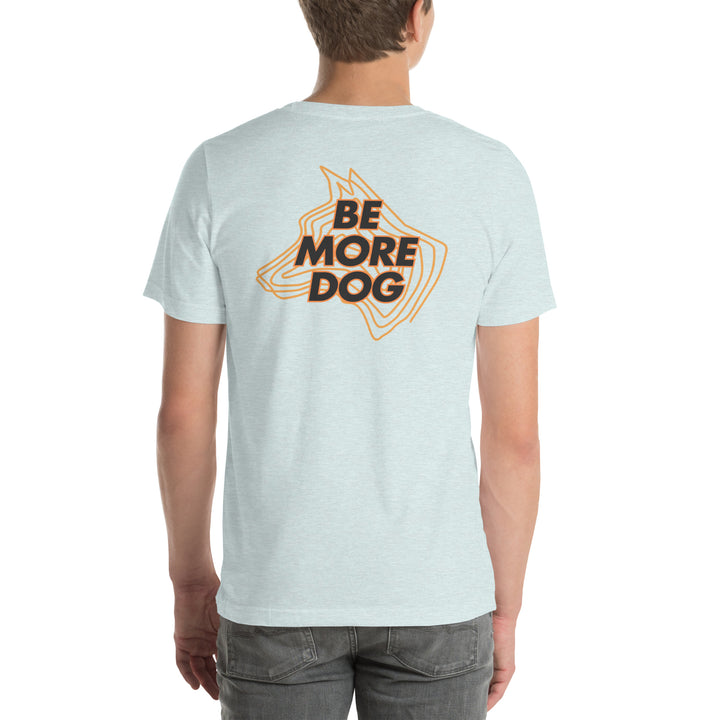 Person wearing a light blue t-shirt with 'Be More Dog' print on the back.