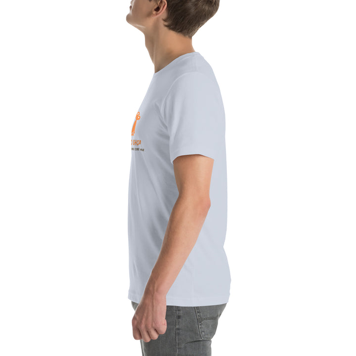 Person wearing a light gray t-shirt with a logo on the chest against a white background